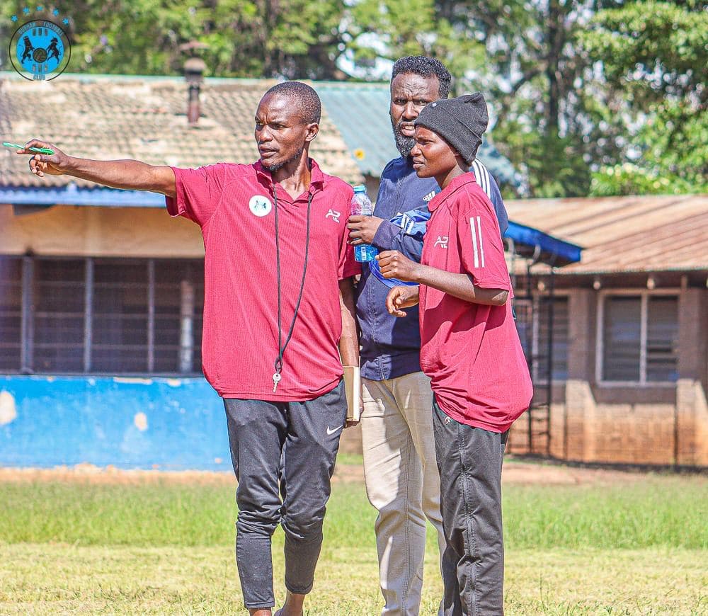 Midfield player scanning the pitch with ball at feet